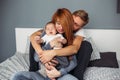 Happy family with newborn baby on the bed Royalty Free Stock Photo