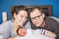 Happy family with newborn baby on the bed in the room Royalty Free Stock Photo