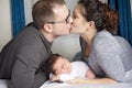 Happy family with newborn baby on the bed in the room Royalty Free Stock Photo