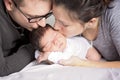 Happy family with newborn baby on the bed in the room Royalty Free Stock Photo