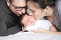 Happy family with newborn baby on the bed in the room Royalty Free Stock Photo