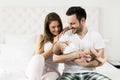 Happy family with newborn baby on the bed in room Royalty Free Stock Photo