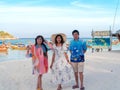 Happy family of old parents and adult daughter standing together at sea view sand beach Royalty Free Stock Photo