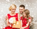 Happy family opening gift box Royalty Free Stock Photo