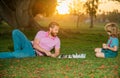 Happy family outdoor. Father and son playing chess in summer garden. Little boy play chess with parent. Cognitive Royalty Free Stock Photo