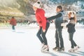 Happy family outdoor ice skating at rink. Winter activities Royalty Free Stock Photo