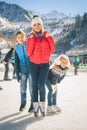 Happy family outdoor ice skating at rink. Winter activities Royalty Free Stock Photo