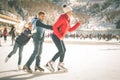 Happy family outdoor ice skating at rink. Winter activities Royalty Free Stock Photo