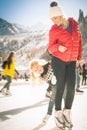 Happy family outdoor ice skating at rink. Winter activities Royalty Free Stock Photo