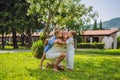 Happy family outdoors on the grass in a park, smiling faces, having fun Royalty Free Stock Photo