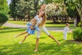 Happy family outdoors on the grass in a park, smiling faces, having fun Royalty Free Stock Photo