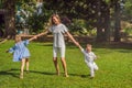 Happy family outdoors on the grass in a park, smiling faces, having fun Royalty Free Stock Photo