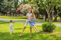 Happy family outdoors on the grass in a park, smiling faces, having fun Royalty Free Stock Photo