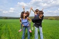 Happy family outdoors on green field Royalty Free Stock Photo