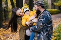 Happy family outdoors. Mother, father and baby on autumn walk in the park Royalty Free Stock Photo