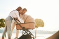 Happy family outdoors. A young couple with a baby pram is walking together Royalty Free Stock Photo