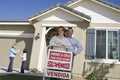 Happy Family Outside Home With Sold Sign Royalty Free Stock Photo