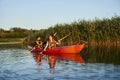 Happy family paddling kayak at sunset Royalty Free Stock Photo