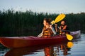 Happy family paddling kayak at sunset Royalty Free Stock Photo