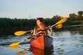 Happy family paddling kayak at sunset Royalty Free Stock Photo