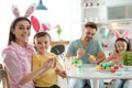 Happy family painting Easter eggs in kitchen Royalty Free Stock Photo