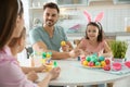 Happy family painting Easter eggs in kitchen Royalty Free Stock Photo