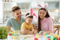 Happy family painting Easter eggs in kitchen Royalty Free Stock Photo