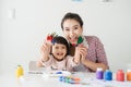 A happy family is painting. Mom help her daughter drawing Royalty Free Stock Photo