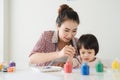 A happy family is painting. Mom help her daughter drawing Royalty Free Stock Photo