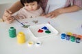 A happy family is painting. Mom help her daughter drawing Royalty Free Stock Photo