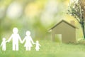 Happy Family paper on green grass see the house for saving money sale. Royalty Free Stock Photo