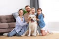 Happy family playing with their favorite pet dog   at home Royalty Free Stock Photo