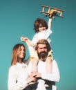 Happy family, Parent giving piggyback ride to children. Mother father and child son on nature on sky. Kid boy with toy Royalty Free Stock Photo