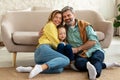 Parents Hugging Little Daughter Posing With Eyes Closed At Home Royalty Free Stock Photo