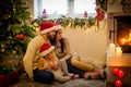 happy family father mother and children sitting by fireplace on Christmas Eve Royalty Free Stock Photo