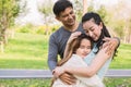 A lovely family hug each other in the park