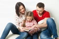 Happy family. Parents reading book with daughter Royalty Free Stock Photo