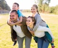 Happy family of parents with two children enjoy a walk in city park Royalty Free Stock Photo