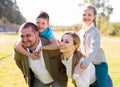 Happy family of parents with two children enjoy a walk in city park Royalty Free Stock Photo