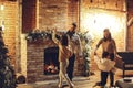 Happy family parents with two kids dancing together near fireplace Royalty Free Stock Photo