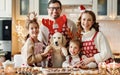 Happy family parents with two kids and golden retriever puppy while making xmas cookies at home Royalty Free Stock Photo