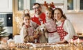 Happy family parents with two kids and golden retriever puppy while making xmas cookies at home Royalty Free Stock Photo
