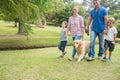 Happy family in the park with their dog Royalty Free Stock Photo