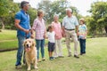 Happy family in the park with their dog Royalty Free Stock Photo