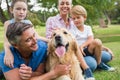 Happy family in the park with their dog Royalty Free Stock Photo