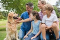 Happy family in the park with their dog Royalty Free Stock Photo