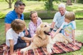 Happy family in the park with their dog Royalty Free Stock Photo