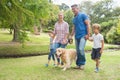 Happy family in the park with their dog Royalty Free Stock Photo