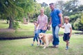 Happy family in the park with their dog Royalty Free Stock Photo