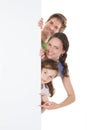 Happy family peeking from blank billboard Royalty Free Stock Photo